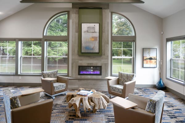 Leasing office lounge area with a fireplace in The Carriages at Fairwood Downs in Renton, Washington