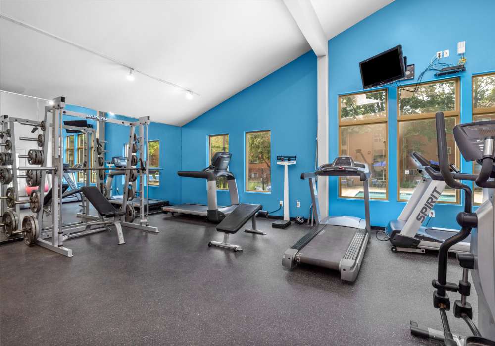 Fitness center with a television at West End Terrace Apartments in St. Louis, Missouri