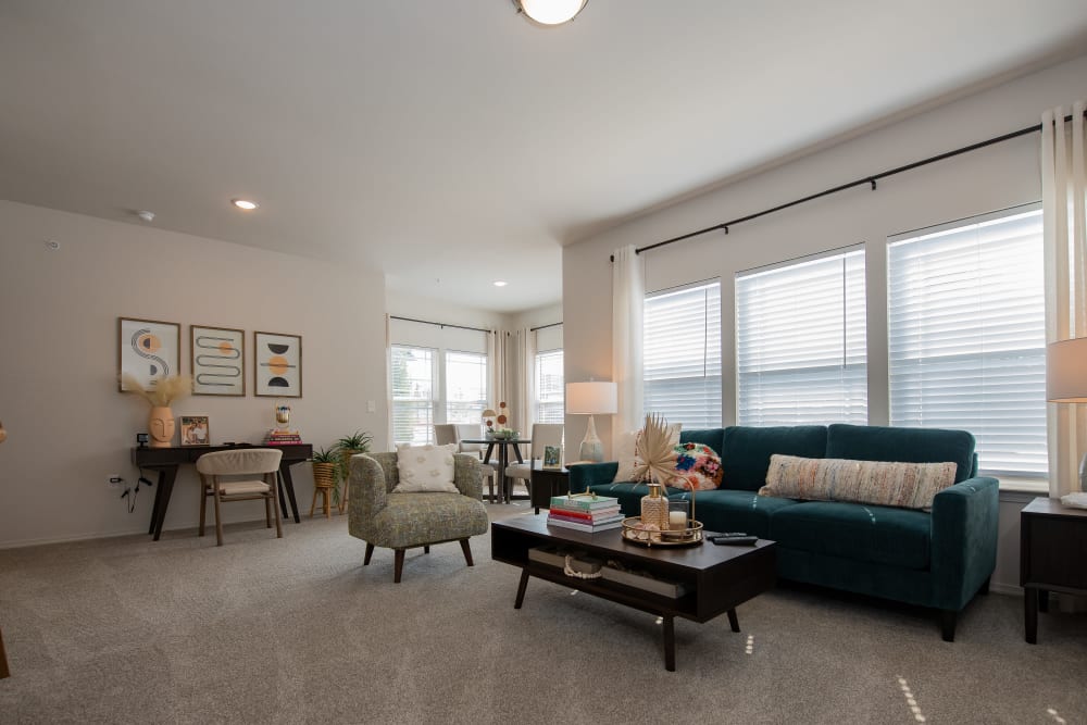 View of the spacious open-concept living area with plush carpeting at 24Hundred Apartments in Oklahoma City, Oklahoma