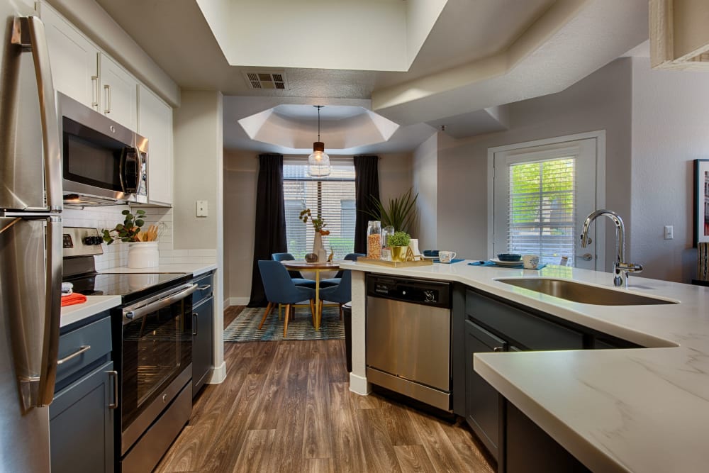 Gourmet kitchen with granite countertops in model home at The Ventura in Chandler, Arizona