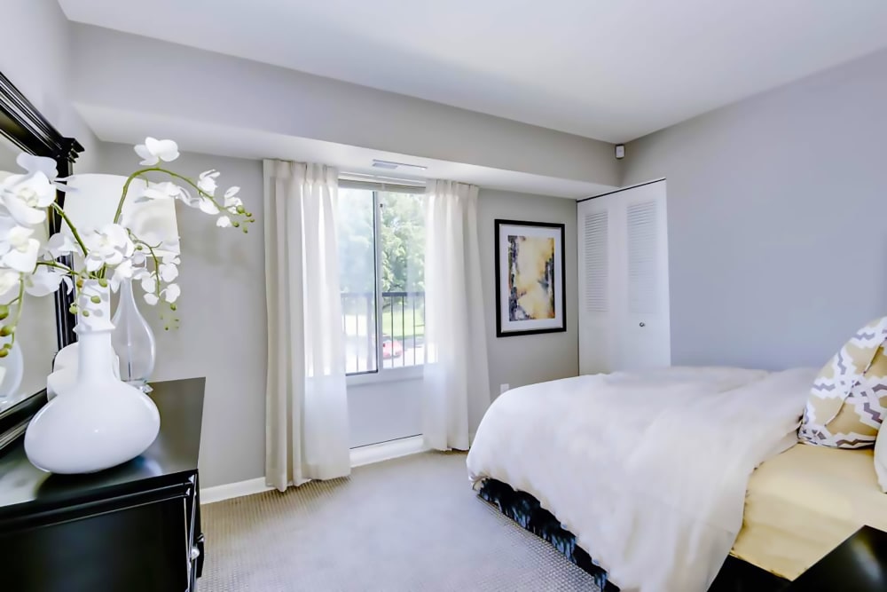 Model bedroom with large windows at Hampton Manor Apartments and Townhomes in Cockeysville, Maryland