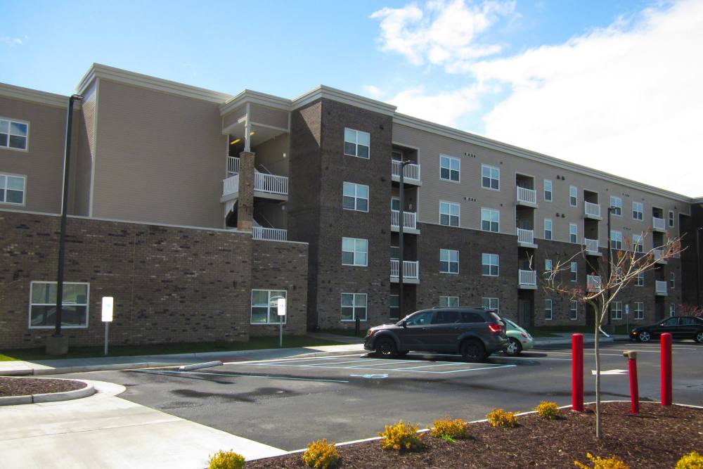Building exterior and cars parked at Brennan Pointe I in Newport News, Virginia