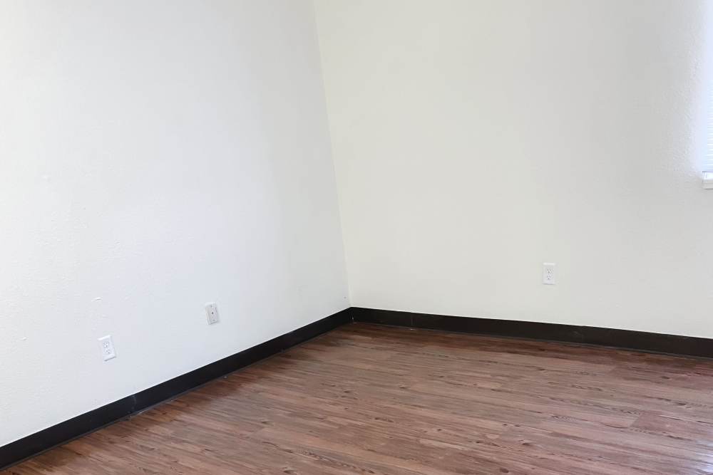 Bedroom with wood-style flooring at Perry Acres Apartments in New Haven, Michigan, 