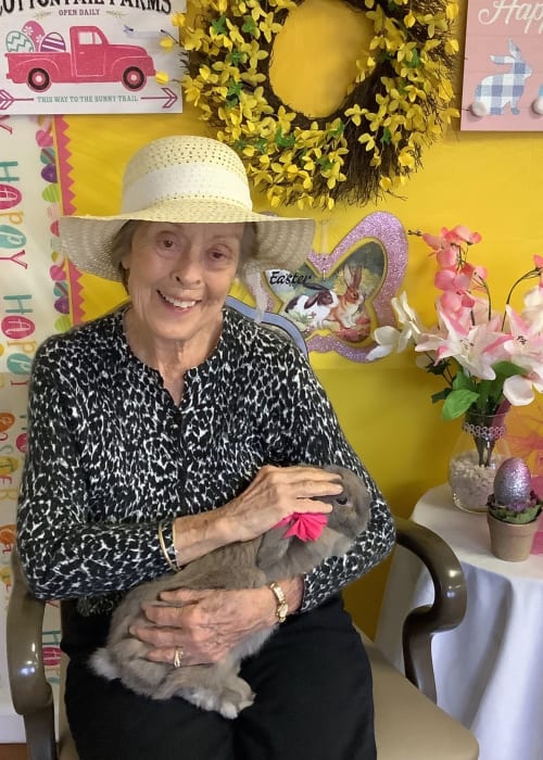 Resident holding a bunny at an Easter event at Grand Villa of Palm Coast in Palm Coast, Florida