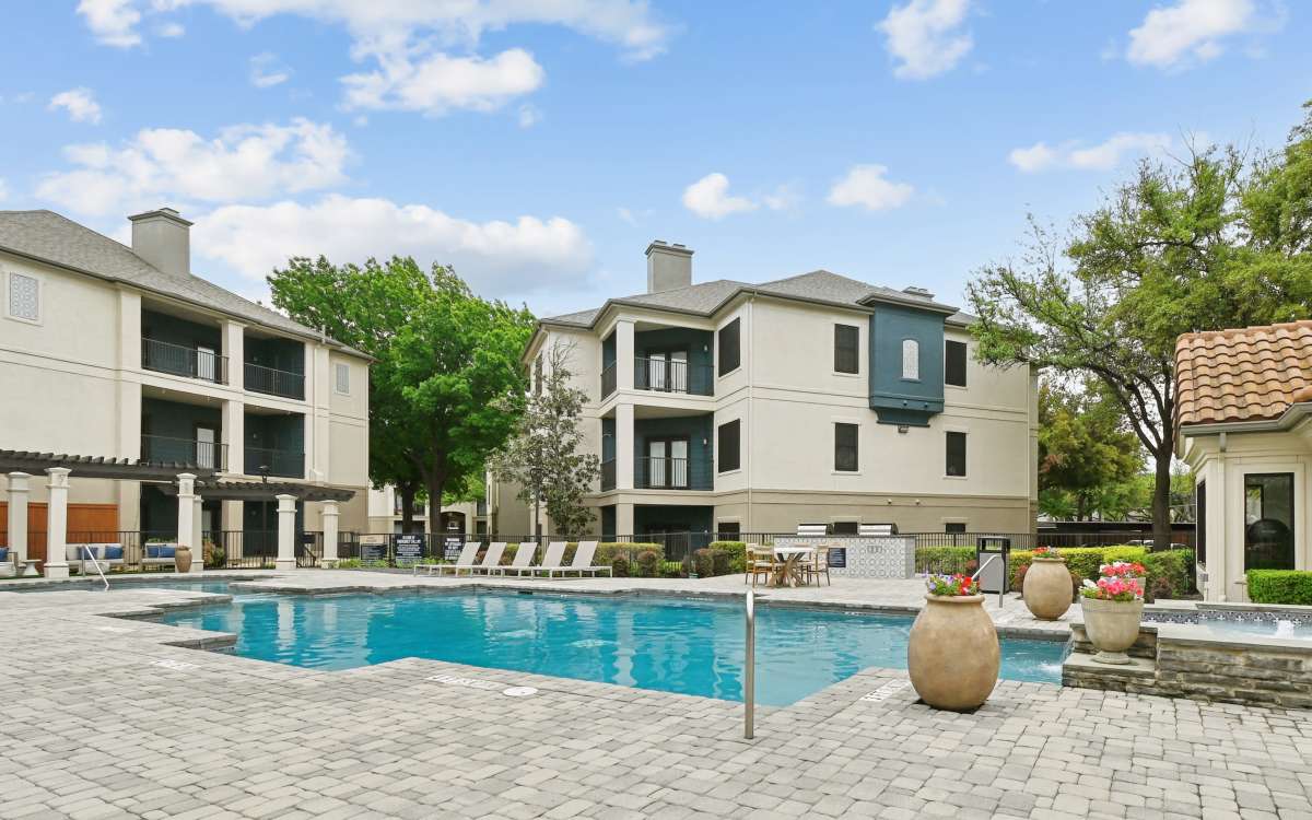 Sunny courtyard pool with greenery at Benton in Dallas, Texas 