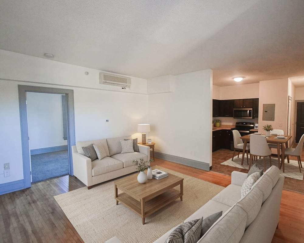 Living room with sofa and dining area at Stradford Flats in Minneapolis, Minnesota