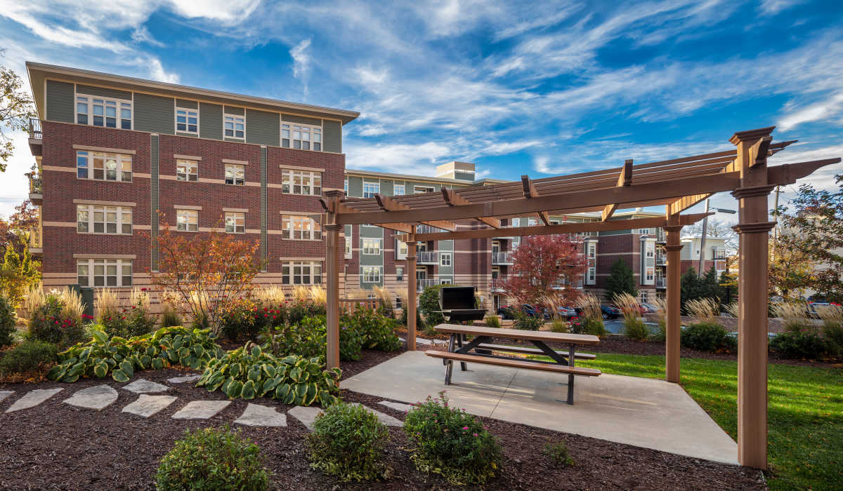 Landscaped courtyard with wooden pergola at Vicinato in Madison, Wisconsin