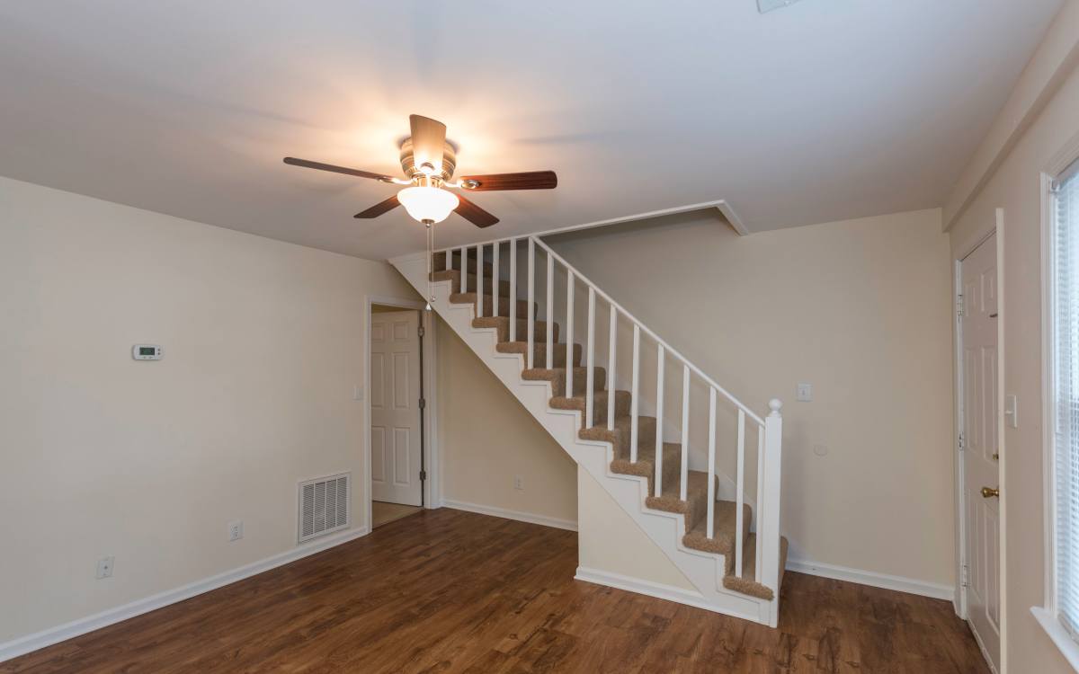 spacious apartment living room with ceiling fan at Fox Chase Apartments in Fredericksburg, Virginia