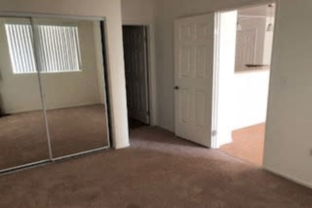 Bedroom with mirrored closet at Oceana Apartments in Huntington Beach, California