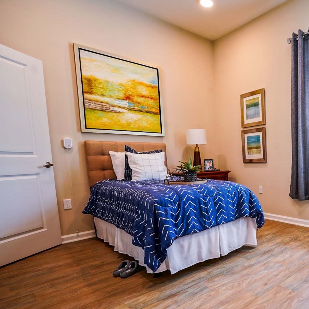 Well-lit bedroom with hard-wood style flooring at Harmony at Mt. Juliet in Mt. Juliet, Tennessee