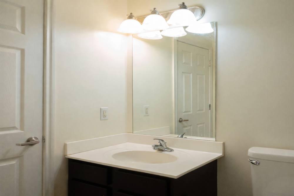 Bathroom showing a vanity mirror and lights at Fairway Breeze in El Reno. OK