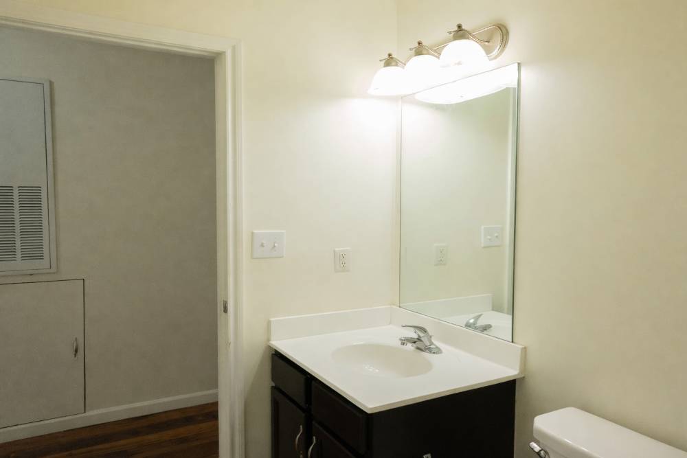 Bathroom showing a vanity sink and lights at Fairway Breeze in El Reno. OK