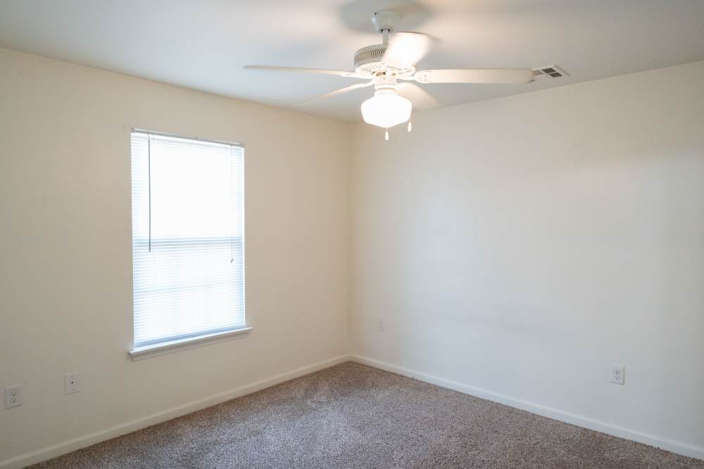 Bright room with ceiling fan and natural light from window at Shawnee Park in Shawnee, Oklahoma