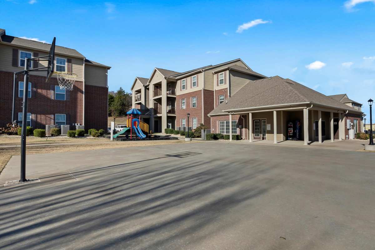 Modern apartment complex with playground and basketball court at Wickham Gardens in Sapulpa, Oklahoma