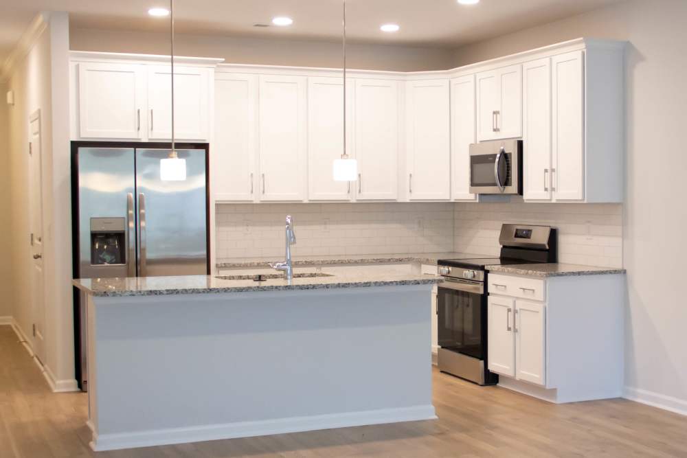 Model kitchen with hardwood floors at Hart Townes in Woodruff, 