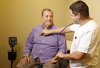 A nurse at Discovery Commons At Bradenton checks a resident's heart rate in Bradenton, Florida