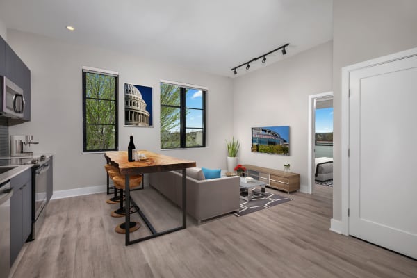 Living room and kitchen with plank flooring at Arcade Sunshine in Washington, District of Columbia
