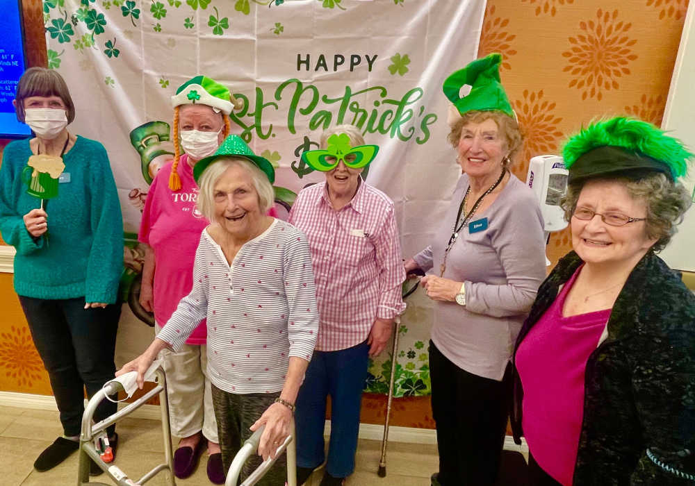 Four residents posing for St. Patrick's Day at Truewood by Merrill, First Hill in Seattle, Washington