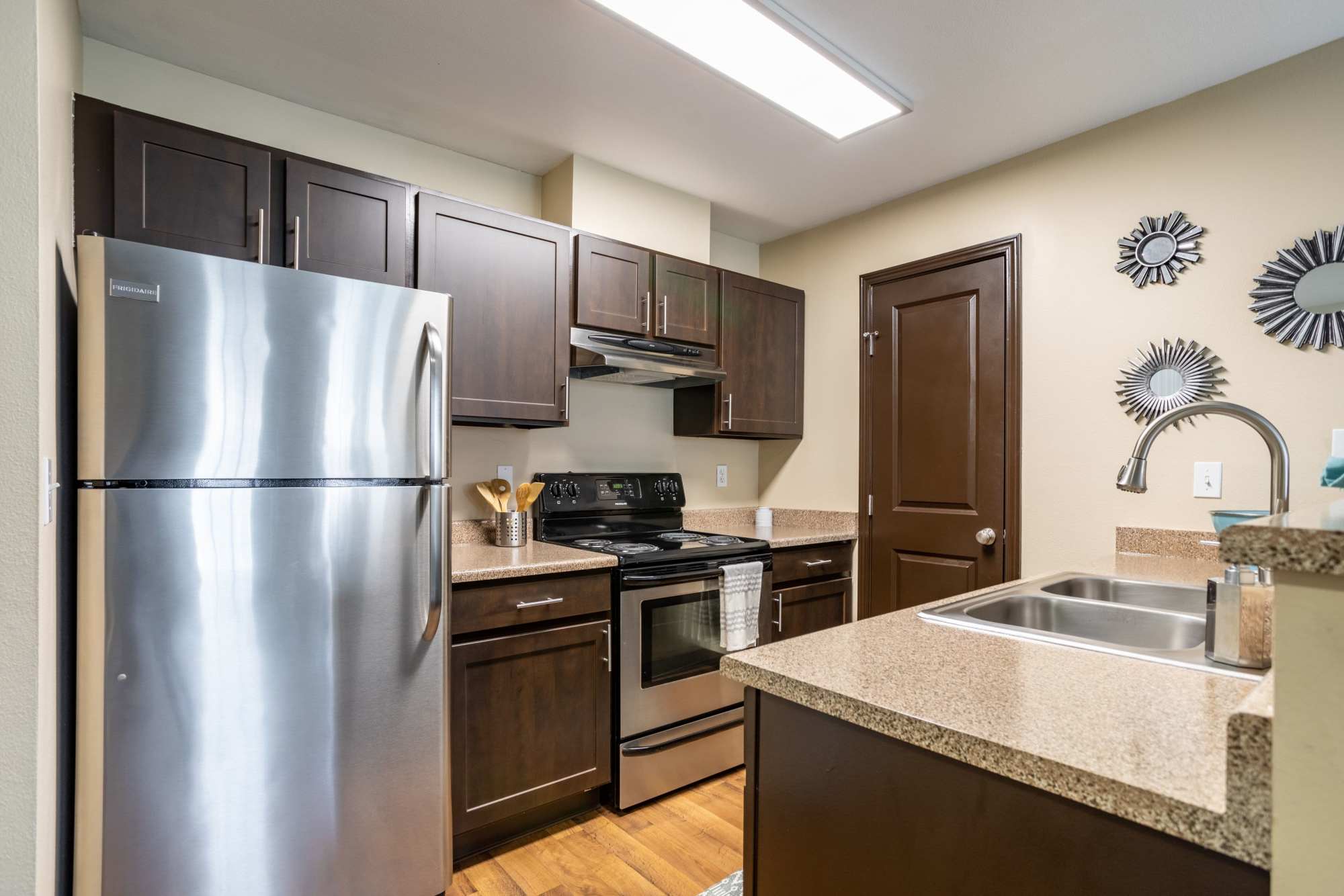 Apartment kitchen with stainless steel appliances at Pebble Cove Apartments in Renton, Washington