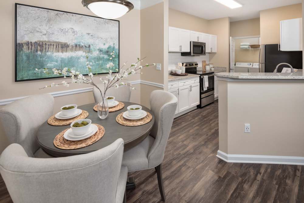 Charming dining area with modern kitchen features and elegant decor at Bryant at Summerville in Summerville, South Carolina.