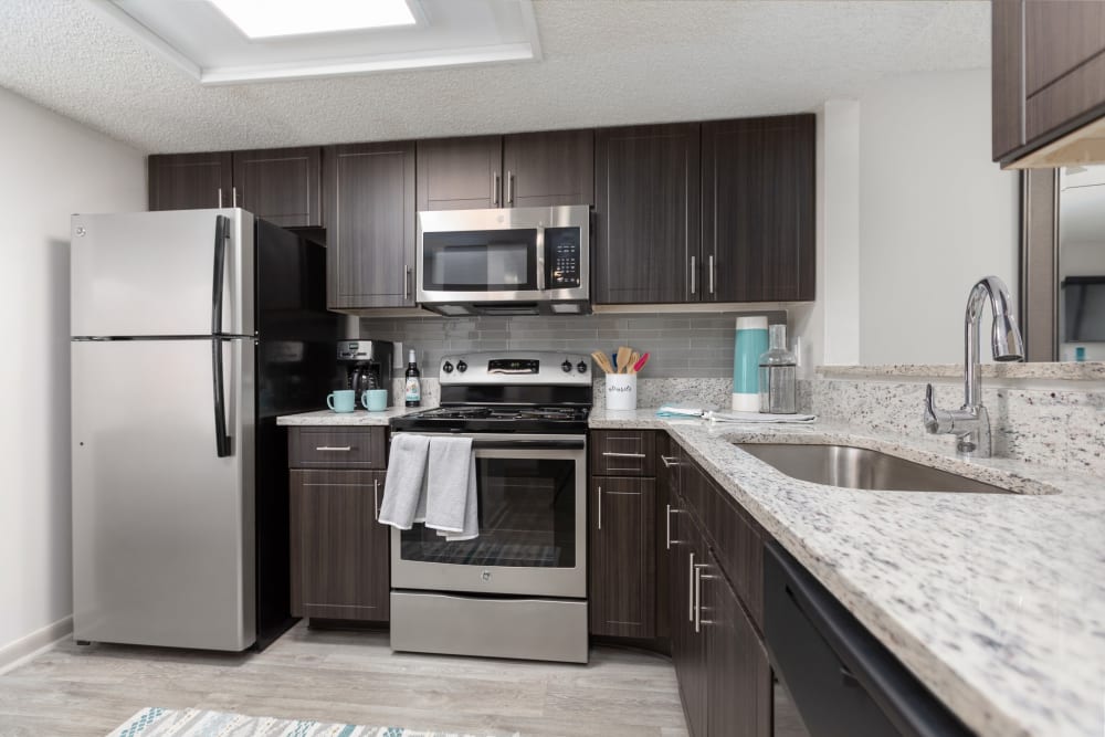 Kitchen with stainless-steel appliances in a model apartment at Siena Apartments in Plantation, Florida