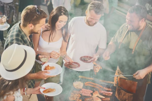Friends grilling and eating lunch at Sobremesa Villas in Surprise, Arizona