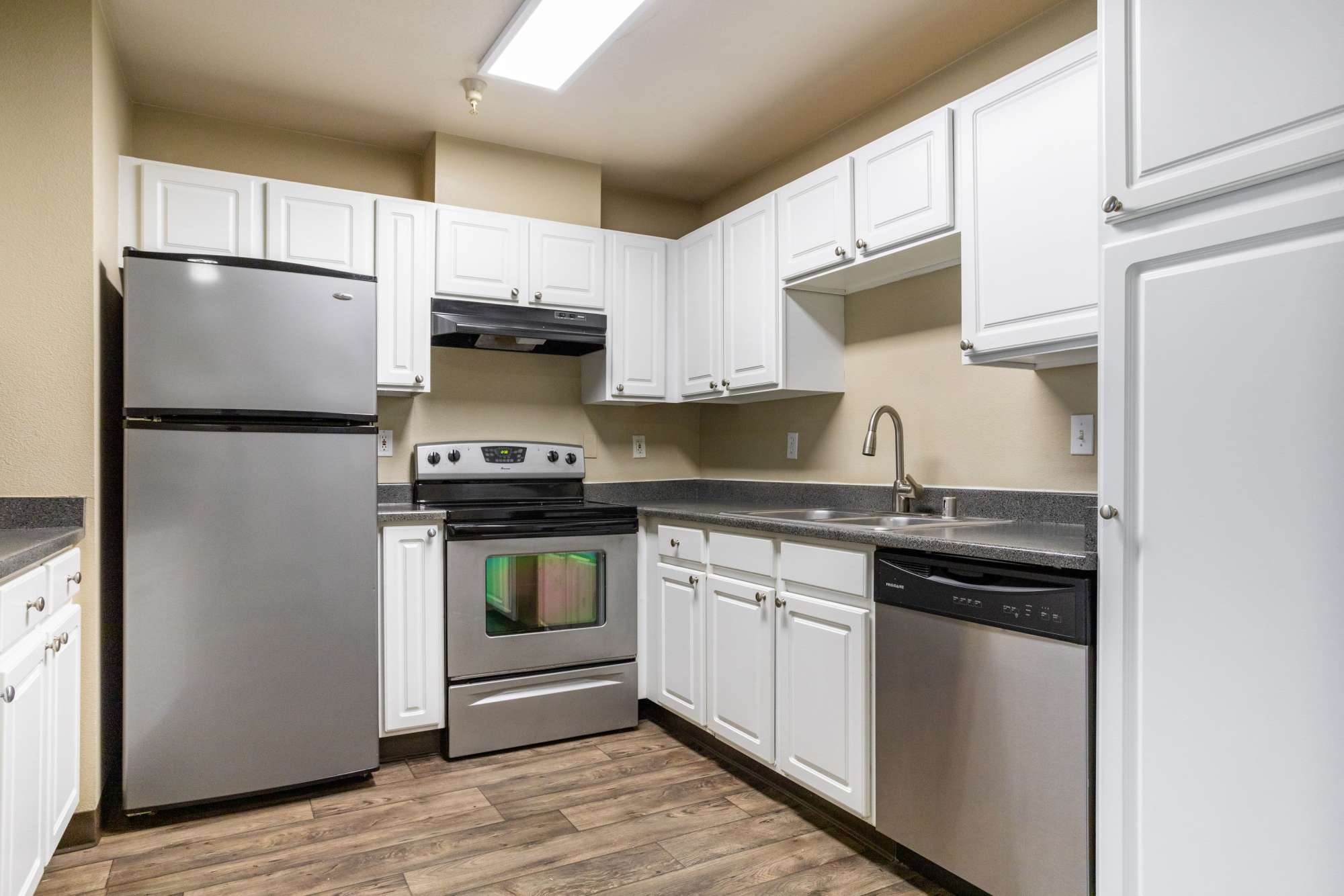 Kitchen with wood flooring at Pebble Cove Apartments in Renton, Washington