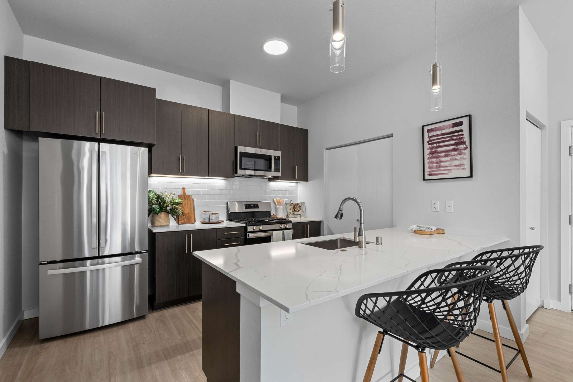 Spacious kitchen with stainless steel appliances & quartz countertops at The Highlands at Silverdale in Silverdale, Washington 