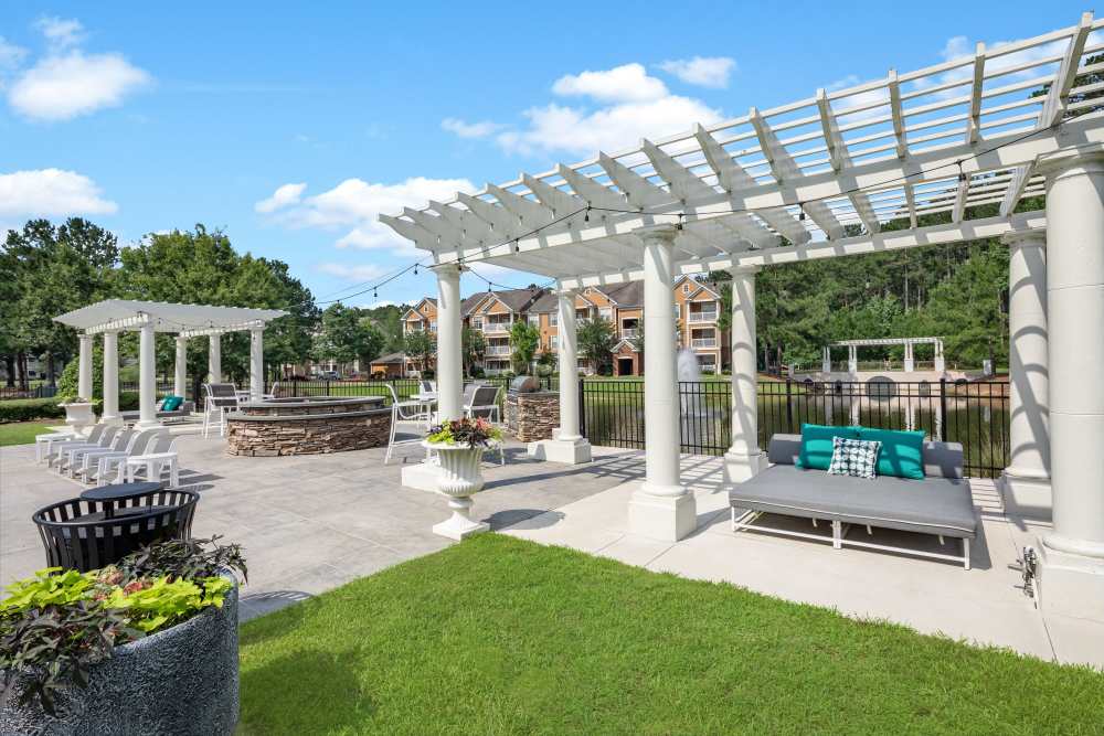 Charming outdoor lounge area with lush landscaping and inviting seating at Bryant at Summerville in Summerville, South Carolina.