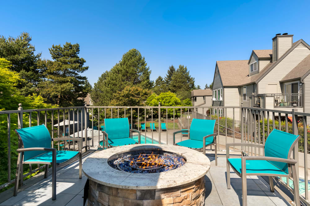 Sundeck and lounge chairs and a fire pit at Meadows at Cascade Park Apartments in Vancouver, Washington