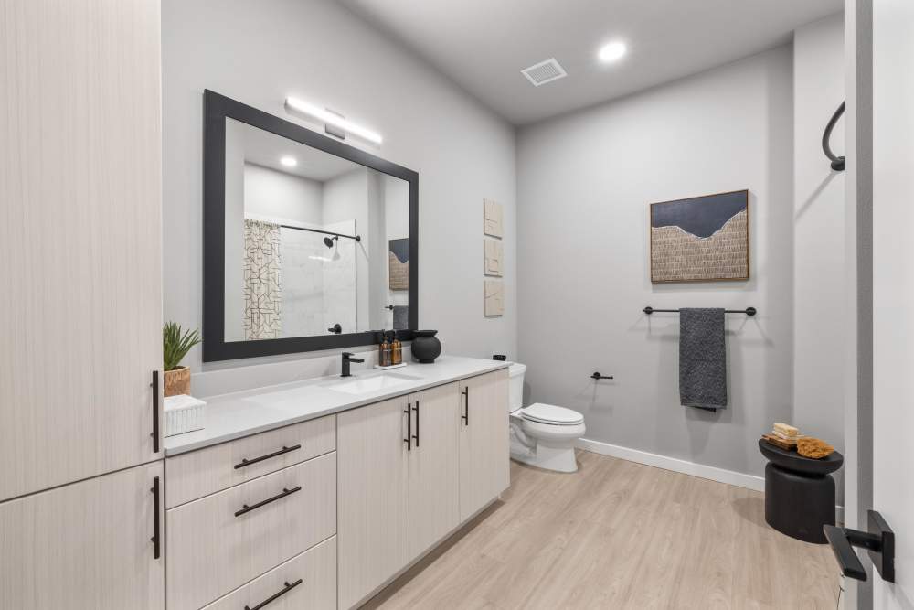 Spacious bathroom with large mirror at The Highlands at Silverdale in Silverdale, Washington