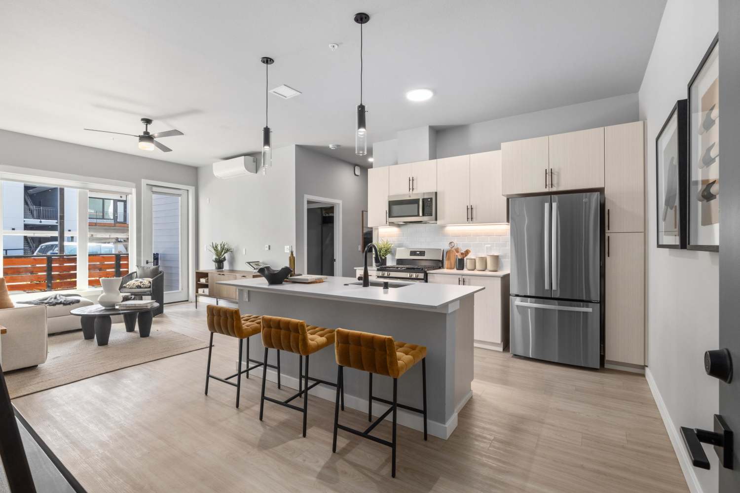 Spacious gorgeous kitchen with island and view of living room at The Highlands at Silverdale in Silverdale, Washington