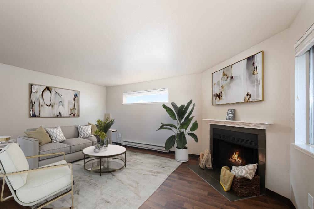 Living room with wood-style flooring at Latitude Apartments in Everett, Washington