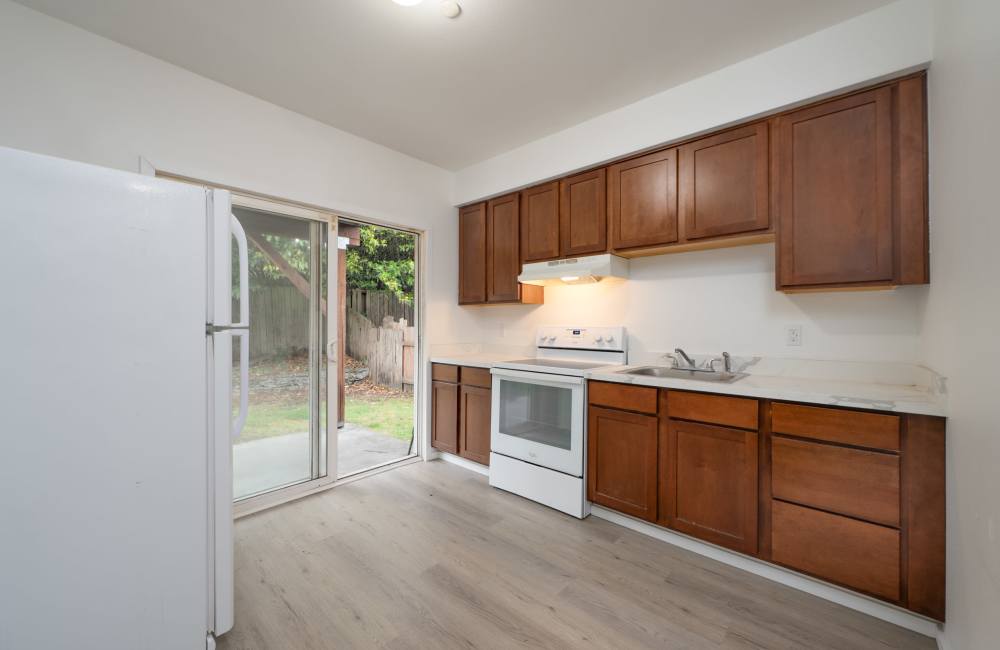 Wooden cabinets and modern appliances in kitchen at The Sage Collection in Tacoma, Washington