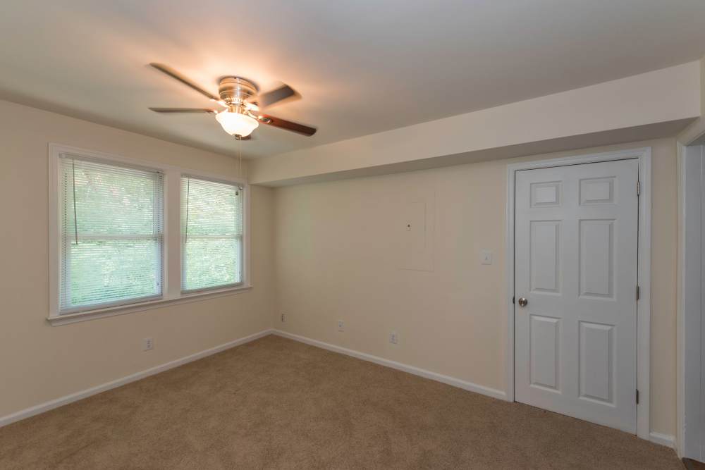 Apartment bedroom with carpet flooring at Fox Chase Apartments in Fredericksburg, Virginia