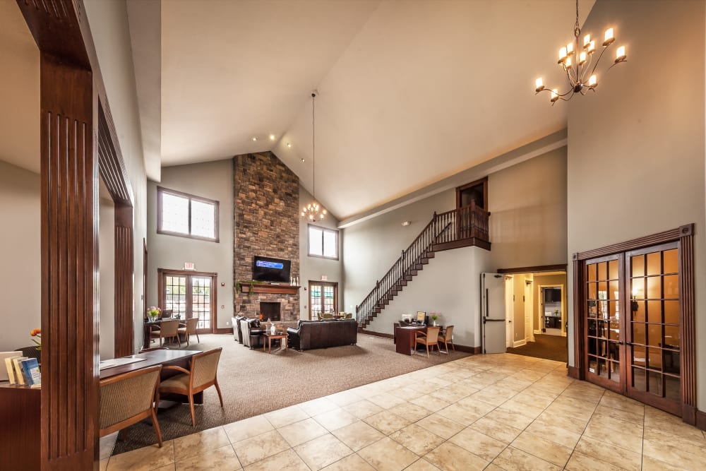 Inviting resident clubhouse with vaulted ceilings and a fireplace at Cobblestone Crossings in Terre Haute, Indiana