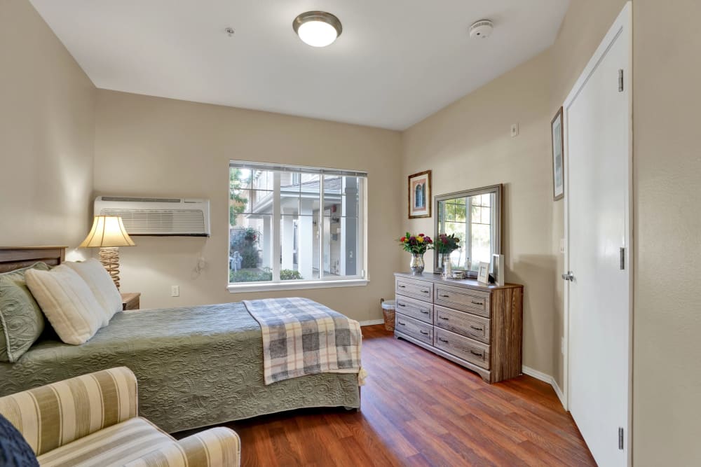 Large bedroom in senior living apartment at The Commons at Elk Grove in Elk Grove, California