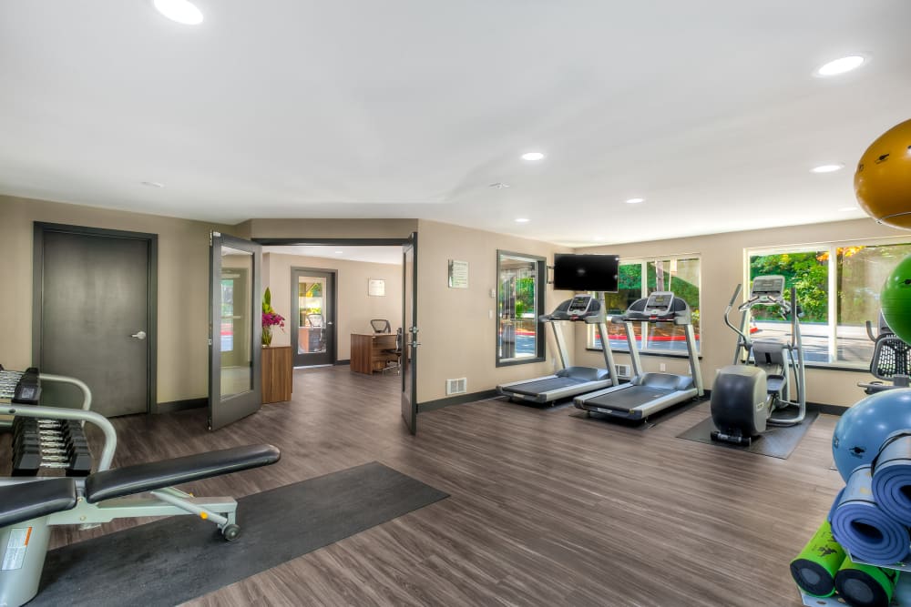 Fitness center with plenty of individual workout stations at Karbon Apartments in Newcastle, Washington