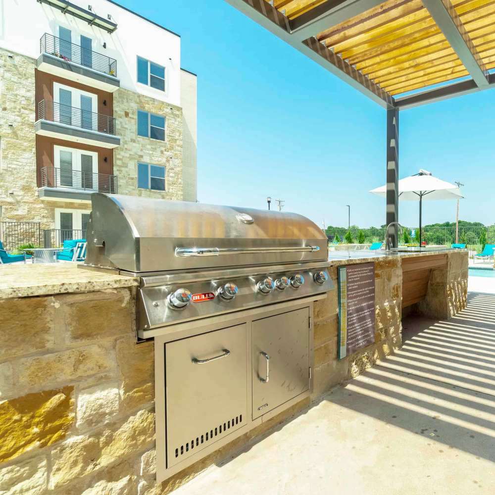 BBQ setup available beside the pool at Millennium Place in Corinth, Texas