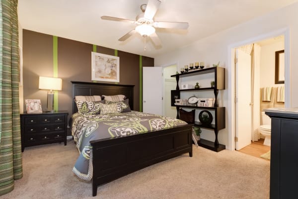 Spacious model bedroom with modern furnishings at Triangle Place in Durham, North Carolina