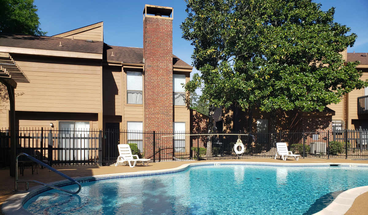 Pool with sundeck at Oaks of Kingwood Apartments in Kingwood, Texas
