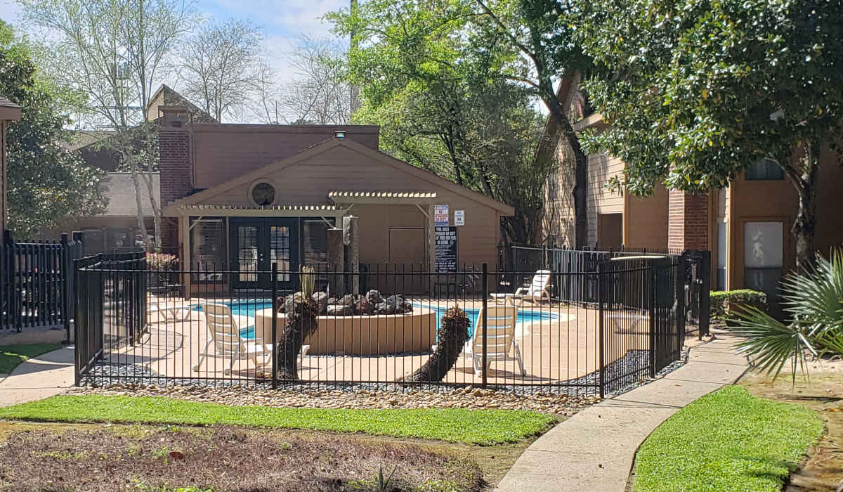 Pool seating area at Oaks of Kingwood Apartments in Kingwood, Texas