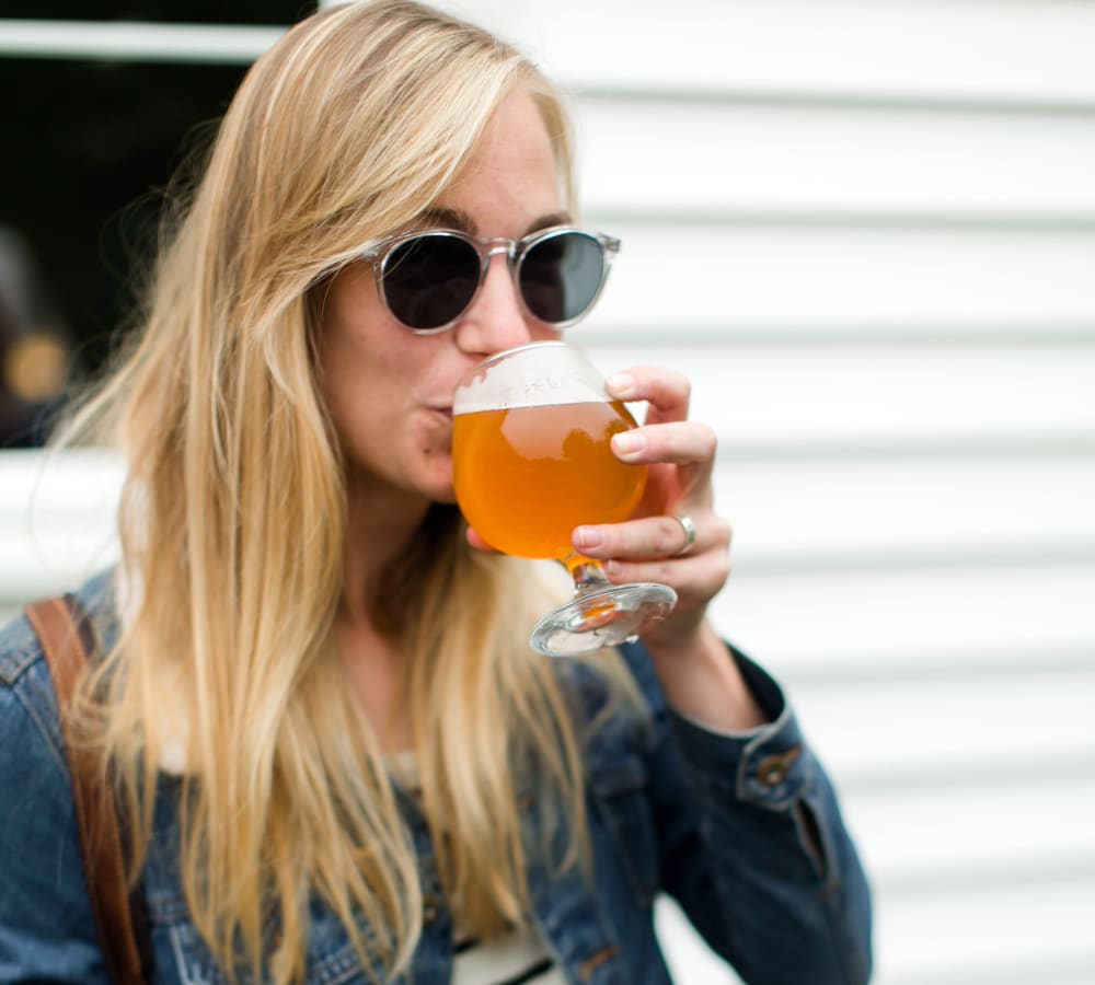 Resident enjoying a Northwest craft brew at her favorite watering hole near Sofi at Murrayhill in Beaverton, Oregon