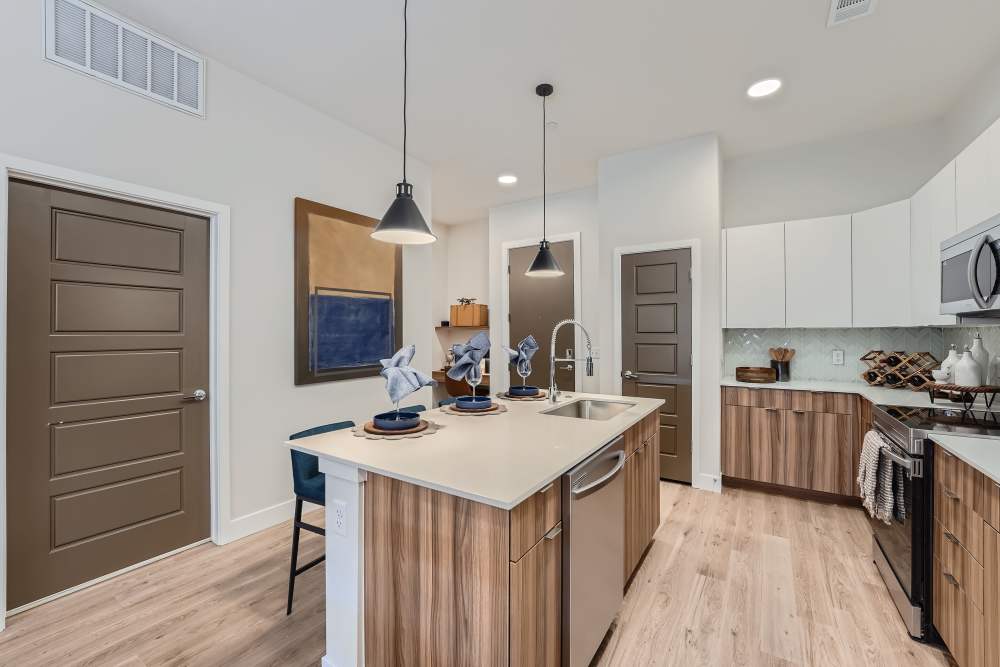 Kitchen with breakfast counter and dishwasher at Flats on the A in Aurora, Colorado