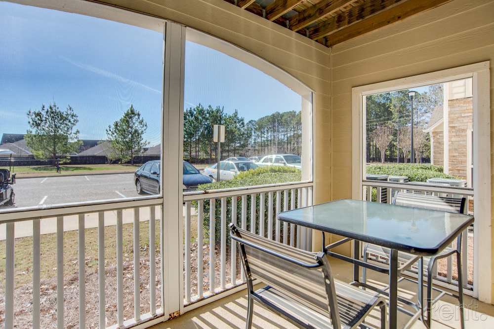 Patio with table and chair at Highland Hills Apartments in Dothan, Alabama