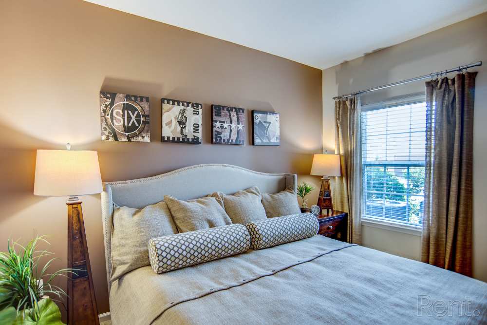 Bedroom with a bed at Highland Hills Apartments in Dothan, Alabama