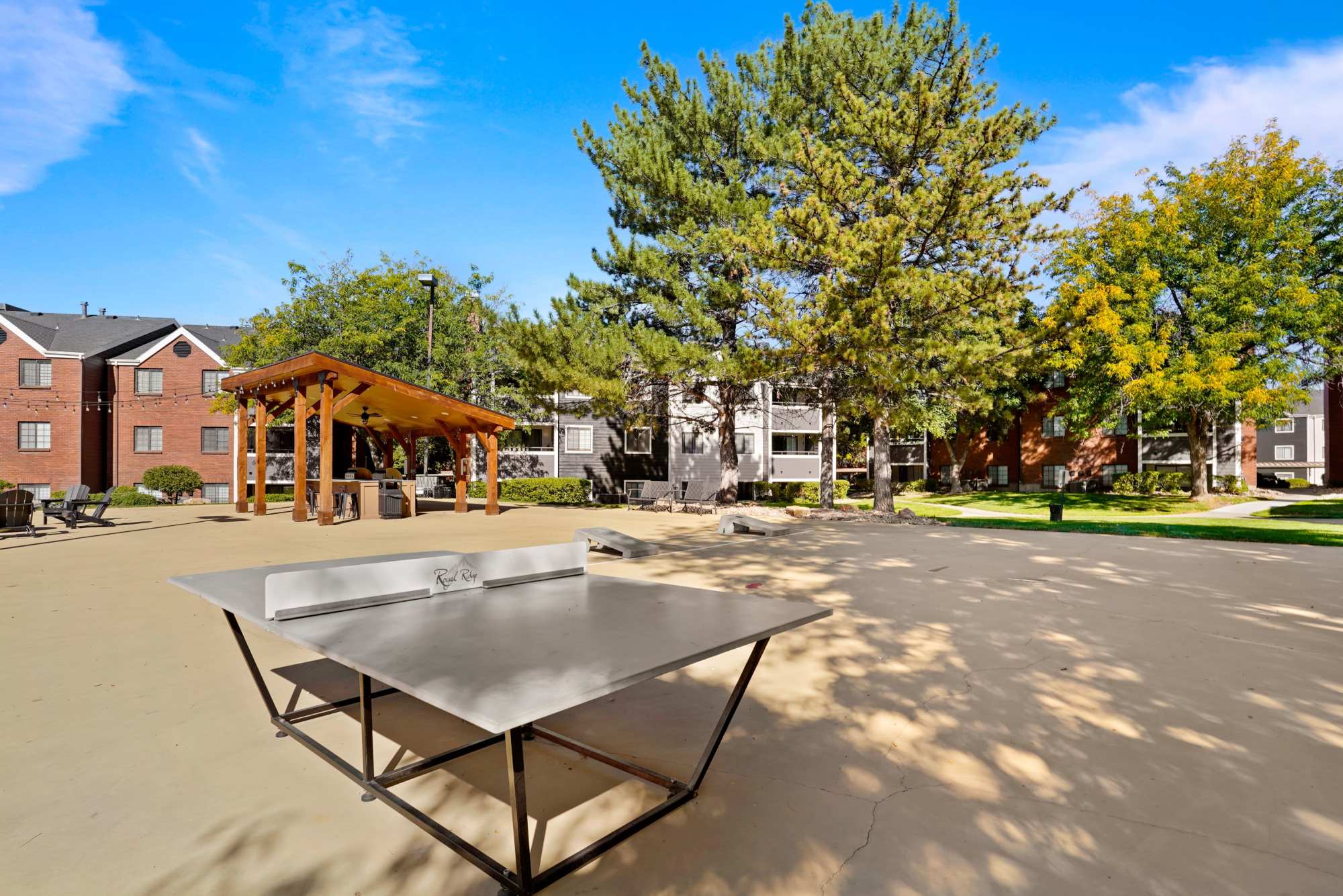 Outdoor game area with table tennis at Royal Ridge Apartments in Midvale, Utah