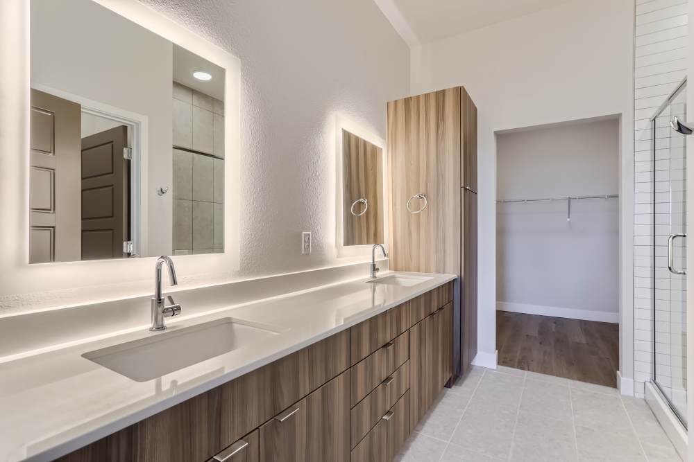 Apartment bathroom with large mirror at Union at the Park in Denver, Colorado