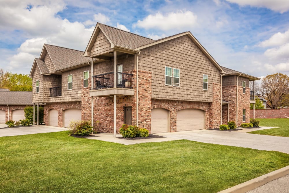 Exterior of a building with balconies and private garages at Cobblestone Crossings in Terre Haute, Indiana