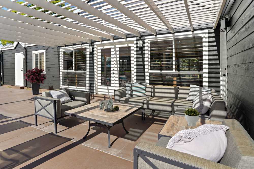 Poolside lounge area with couches at Royal Ridge Apartments in Midvale, Utah